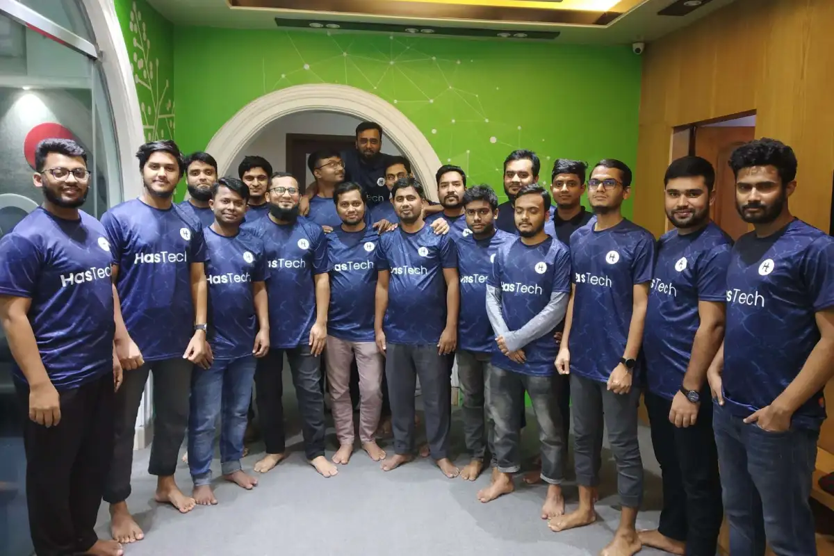 Shaddam Hossain with teammates at HasTech IT Ltd. during a team group photo inside the office.